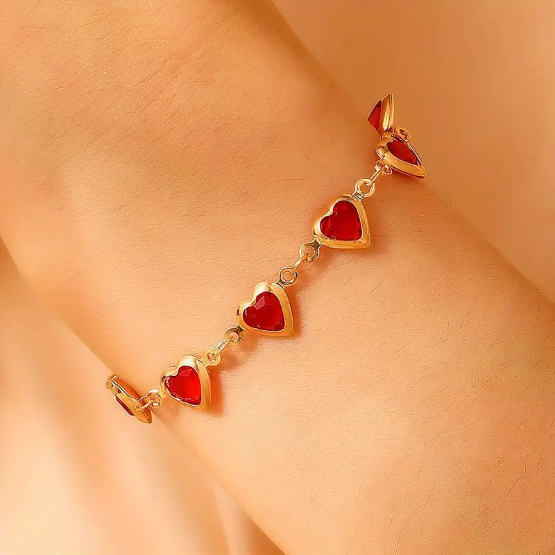 Gold chain bracelet with ruby heart