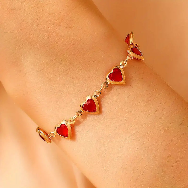 Gold chain bracelet with ruby heart