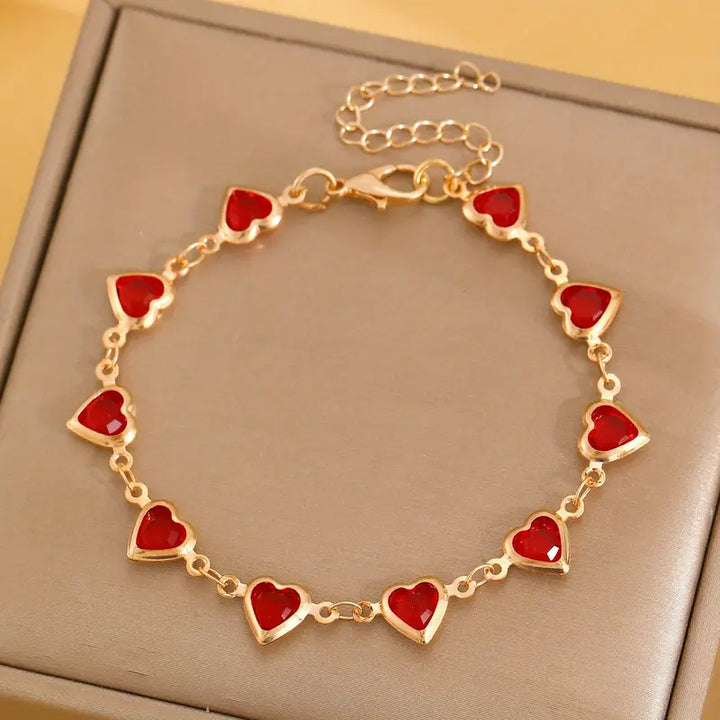 Gold chain bracelet with ruby heart