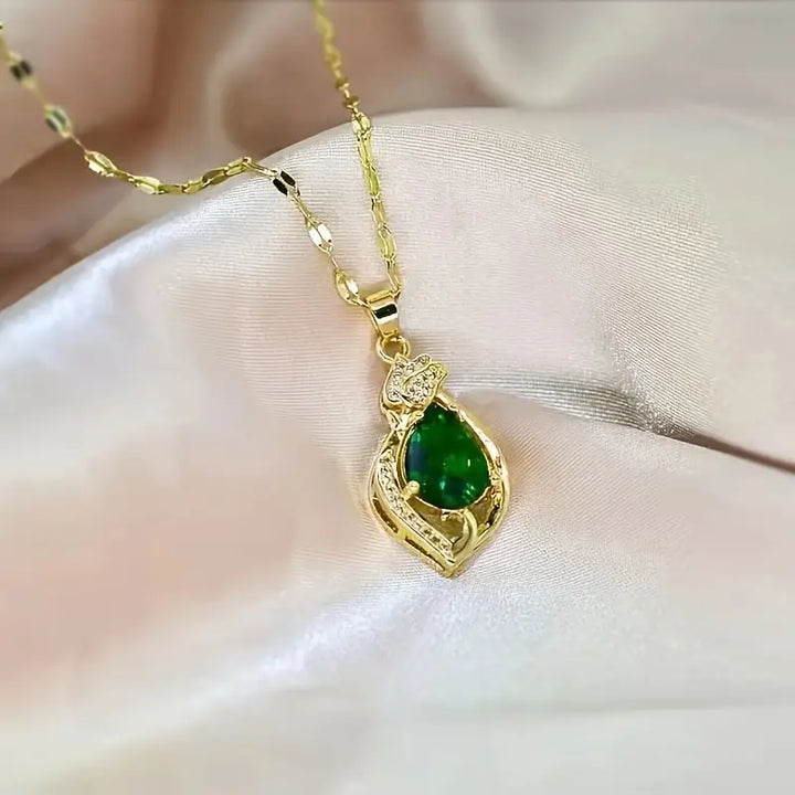 Necklace with a gold teardrop-shaped emerald pendant