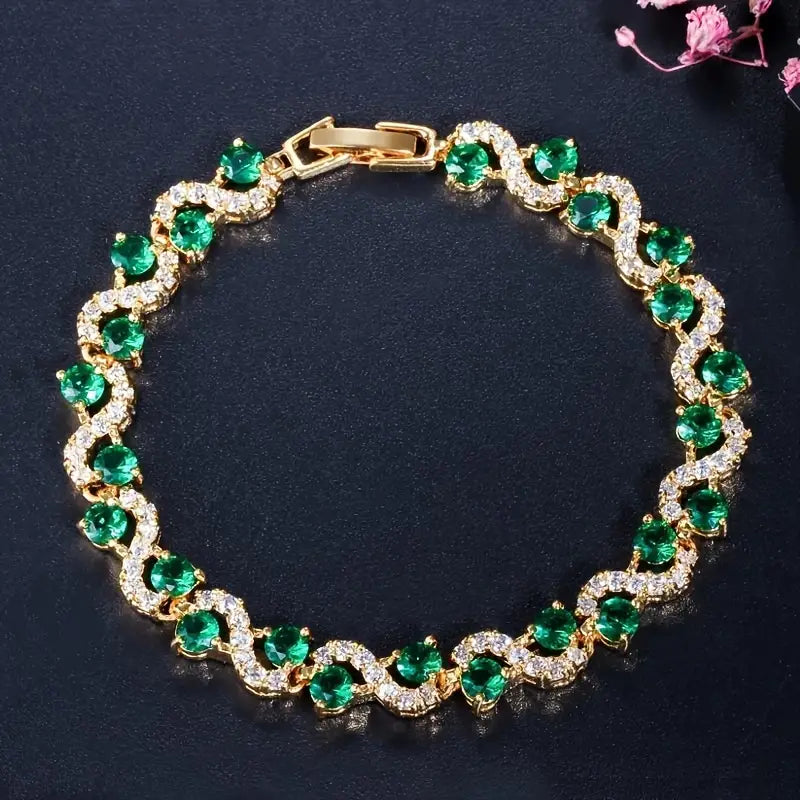 Gold halo bracelet with emerald