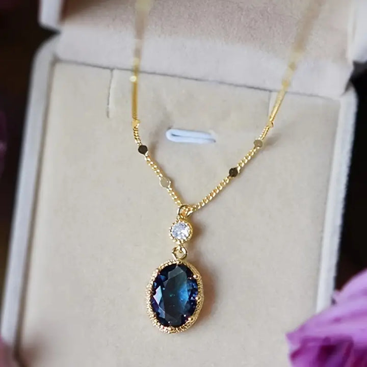 Gold necklace with oval sapphire pendant (teardrop style)