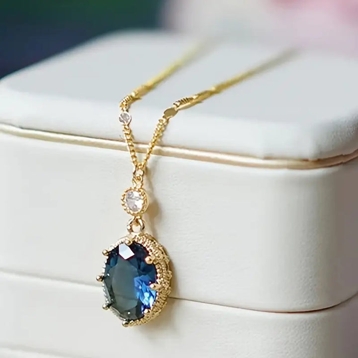 Gold necklace with oval sapphire pendant (teardrop style)