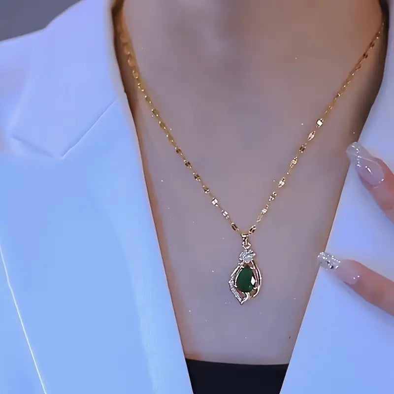 Necklace with a gold teardrop-shaped emerald pendant