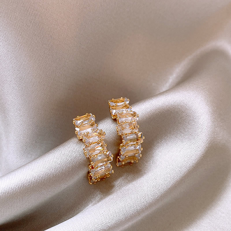 Elegant gold earrings with sparkling zircon