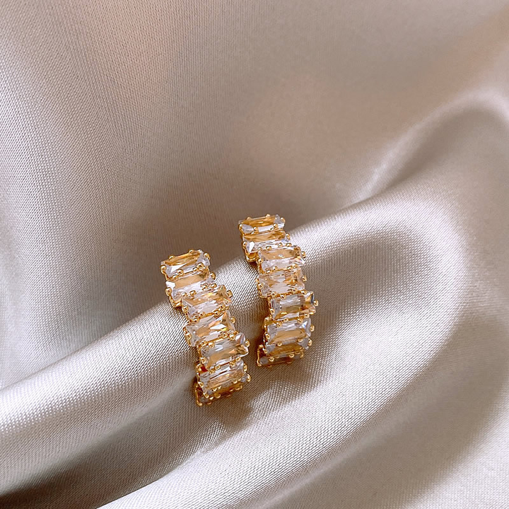 Elegant gold earrings with sparkling zircon