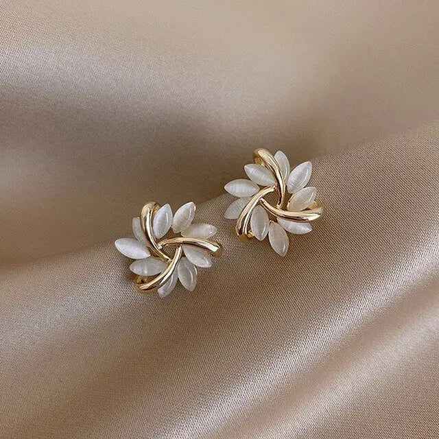 Gold leaf stud earrings with white opal